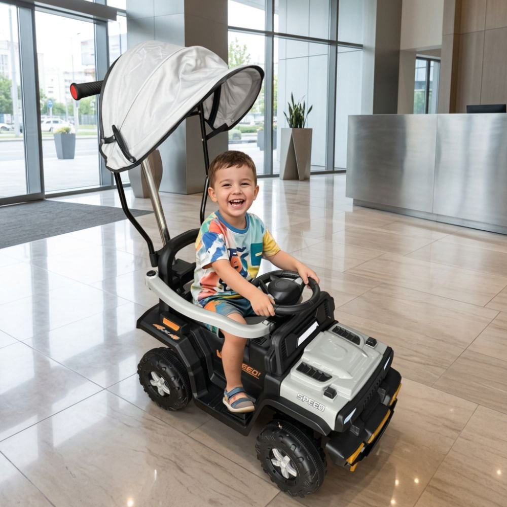 kids-electric-push-car-grey-parent-handle-canopy-nepal Happy toddler riding a grey kids electric push car with parent handle and canopy at Kids Kart Nepal.